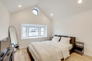 a bedroom with a large bed and a window at Home with Lake Views and Deck in New Jersey Highlands! in Stanhope