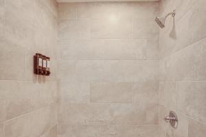 a bathroom with a shower with beige tiles at Home with Lake Views and Deck in New Jersey Highlands! in Stanhope +16 photos