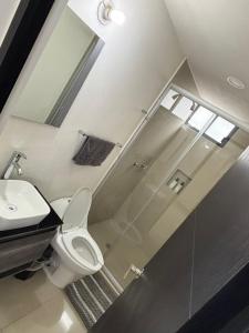 a bathroom with a shower and a toilet and a sink at Estancia del Volcán in Santa María Coronanco