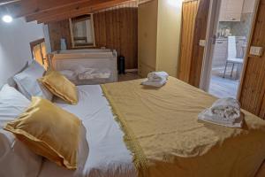 a bedroom with a large bed with towels on it at Casa di Rosy in San Sperate