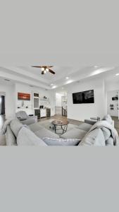 a living room with a couch and a tv at Paradise Villa: 2 blocks from beach, private pool in South Padre Island