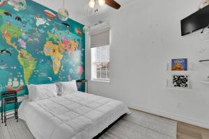 a bedroom with a map of the world on the wall at Paradise Villa: 2 blocks from beach, private pool in South Padre Island +52 photos