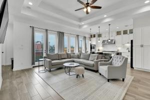a living room with a couch and chairs and a kitchen at Paradise Villa: 2 blocks from beach, private pool in South Padre Island