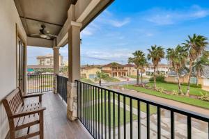 a balcony with a bench and a view of a street at Paradise Villa: 2 blocks from beach, private pool in South Padre Island