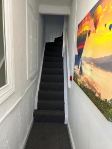 a stairway with a painting on the wall at The Down Town Chambers in Bournemouth