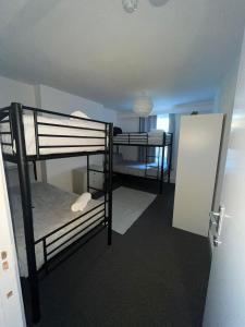a room with two bunk beds and a door at The Down Town Chambers in Bournemouth +9 photos