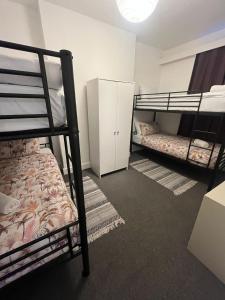 a bedroom with two bunk beds and a closet at The Down Town Chambers in Bournemouth