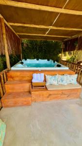 a large wooden boat with a tub in it at Eliza, Bangalô vista mar em Trancoso in Trancoso +44 photos