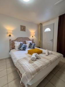 a bedroom with a large bed with towels on it at MY Tropézienne in Saint-Tropez