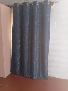 a black curtain hanging in a room at Miale Guests Cottages in Kiamuringa