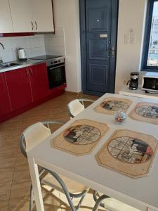 a kitchen with a table with four pictures on it at Dimitris House in Karistos +12 photos