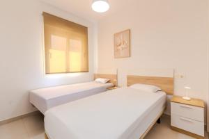 En eller flere senge i et værelse på Relaxing Home Gran Alacant more than 11 days + 22 billeder