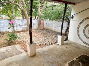 a patio with a fence and a tree in it at Casa Leon Rinconada in Puerto Escondido +10 photos