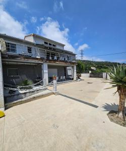 a house with a large driveway in front of it at Paradiso Apartment 4 people in Furiani