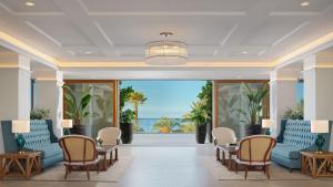 a lobby with blue furniture and a view of the ocean at Gran Hotel Taoro in Puerto de la Cruz