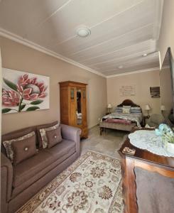 un soggiorno con un divano e un letto di Goedehoop a Somerset West