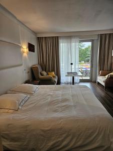 a hotel room with a large bed and a balcony at studio, Anglet Chiberta ocean golf surf in Anglet +22 photos