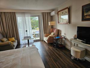 a hotel room with a bed and a flat screen tv at studio, Anglet Chiberta ocean golf surf in Anglet