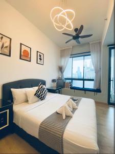a bedroom with a bed with a ceiling fan at The Luxe KLCC by Infinitum in Kuala Lumpur