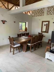a dining room with a wooden table and chairs at Finca El Cural in Sasaima