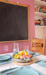 a table with a plate of fruit and a blackboard at Exesixteen in Exeter