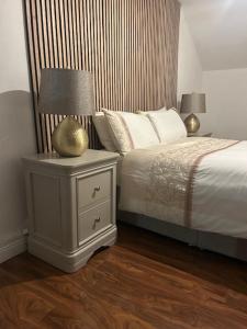 a bedroom with a bed and a lamp on a night stand at Tranquility in Longford