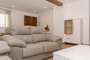 a living room with a couch and a tv at Pico Mágina in Albanchez de Magina +24 photos