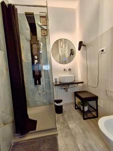 a bathroom with a shower and a sink and a mirror at Le Stanze di Bimba in Terni