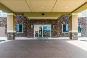 a large brick building with a large glass door at Comfort Inn & Suites Valdosta in Valdosta