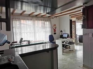 a kitchen with a counter top and a desk at Tikki Lua in Cota