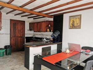 a kitchen with a table with a laptop on it at Tikki Lua in Cota +19 photos
