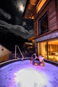 two children in a hot tub at night at Haus Melisande in Sölden