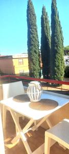 a white table and chairs with trees in the background at Etrusca shabby chic apartment - Tuscany - Venturina Terme in Venturina Terme