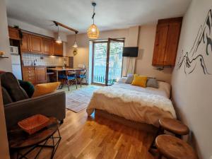 a bedroom with a bed and a living room and a kitchen at Tu rincón rústico con balcón y vistas - Erta 2 in Pla de l'Ermita +13 photos