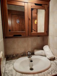 a bathroom with a sink and a cabinet and towels at Tu rincón rústico con balcón y vistas - Erta 2 in Pla de l'Ermita