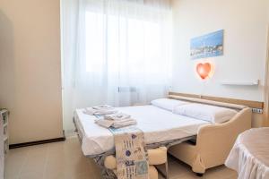 a hospital room with a bed and a heart balloon at Riva chiara in Toscolano Maderno