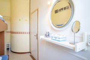 a bathroom with a mirror on the wall at Riva chiara in Toscolano Maderno +7 photos