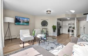 a living room with a couch and a table at Contemporary, cozy & easy to Rocky Mountains from Calgary ! in Calgary