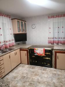 a kitchen with white cabinets and a counter top at Casa Castro in A Estrada +6 photos
