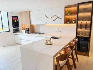 クエンカにあるDepartamentos SKYHOMEの白いキッチン(大きな白いカウンタートップ付)