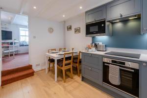a kitchen with a table and a stove top oven at 2 Bed in St. Ives oc-b31979 in St Ives +9 photos