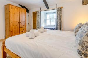 a large white bed in a room with a window at 2 Bed in St. Ives oc-b31979 in St Ives