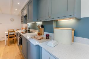 a kitchen with blue cabinets and a counter top at 2 Bed in St. Ives oc-b31979 in St Ives