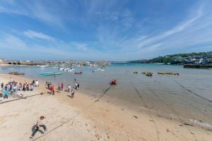 a group of people standing on a beach at 2 Bed in St. Ives oc-b31979 in St Ives