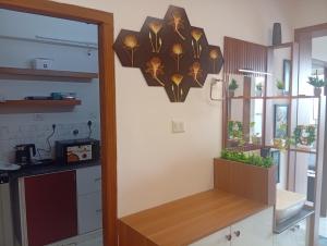 a kitchen with a large clock on the wall at Gurunandanam-Fully furnished Deluxe Apartment East Nada Guruvayur in Guruvāyūr