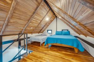 a bedroom with a bed in a attic at 5 Lofts En La Paraiso in Playa Grande +41 photos