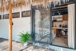 a patio with two chairs and a table at 5 Lofts En La Paraiso in Playa Grande