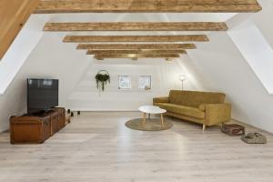 a living room with a couch and a table at "Alte Post" in Münsingen