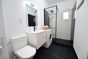 a white bathroom with a toilet and a sink at FLH - Moonwalk in Sibiu