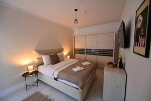 a bedroom with a large bed and a television at FLH - Moonwalk in Sibiu